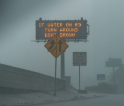 highway sign gives safety tips during heavy rain and hurricane conditions