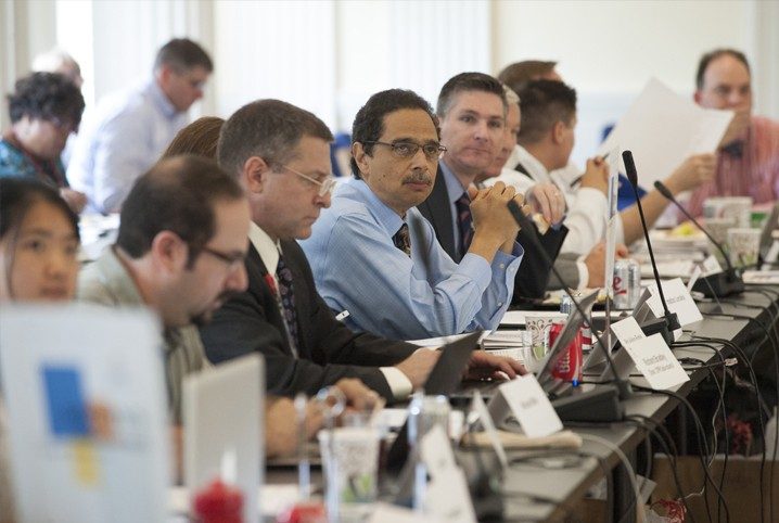 scientific advisory council members discussing topics at long table